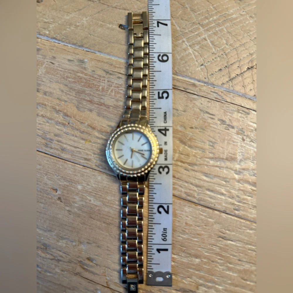 Anne Klein Gold-Tone Crystal Bezel Women's Watch with Mother-of-Pearl Dial